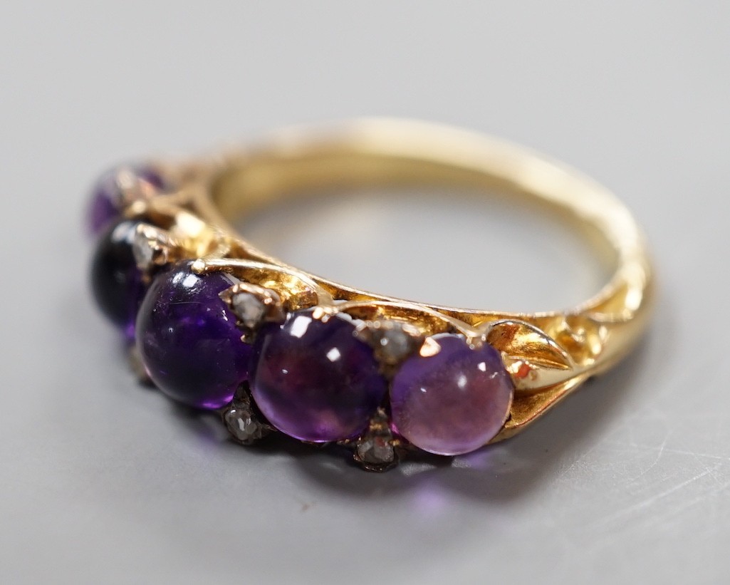 A late Victorian yellow metal and five stone graduated cabochon amethyst set half hoop ring, with rose cut diamond chip spacers, size M, gross weight 4.7 grams.